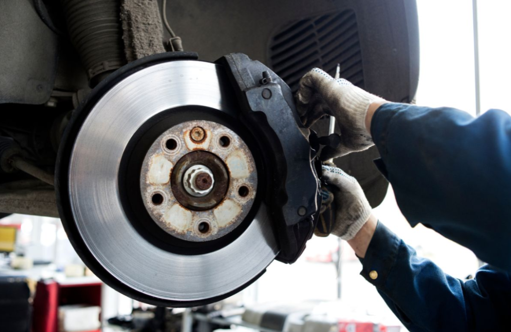 A mechanic working on a set of brakes.