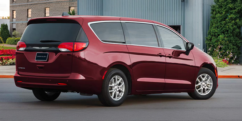 2026 Maroon Chrysler Voyager parked on front of building
