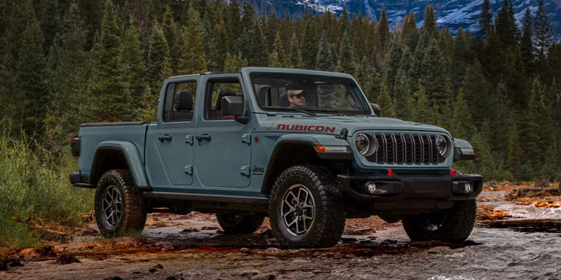 2026 Jeep Gladiator Standing in mountains in its front side profile