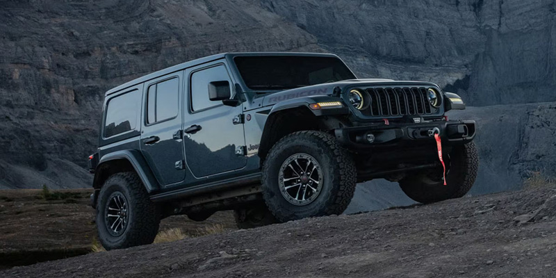 2026 Dark Blue Jeep Wrangler Climbing rock hills showing its capabilities