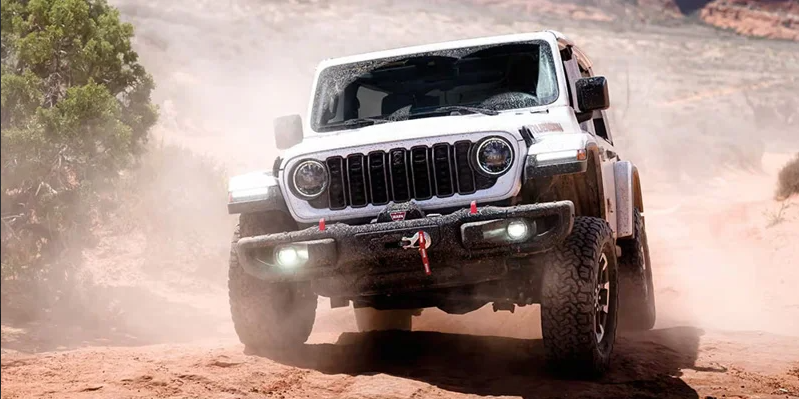 A white 2026 Jeep Wrangler off-roading.