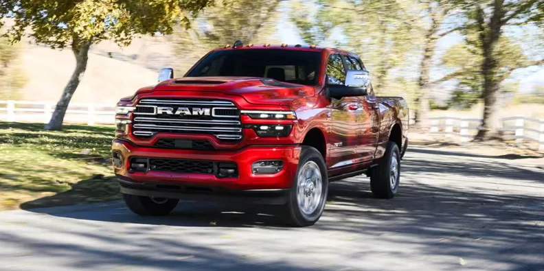 A red 2026 RAM 2500 driving down the road.