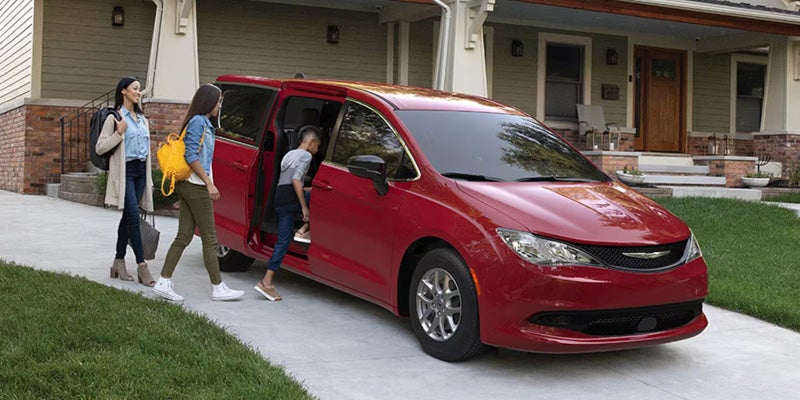 Red 2026 Chrysler Voyager parked outside home