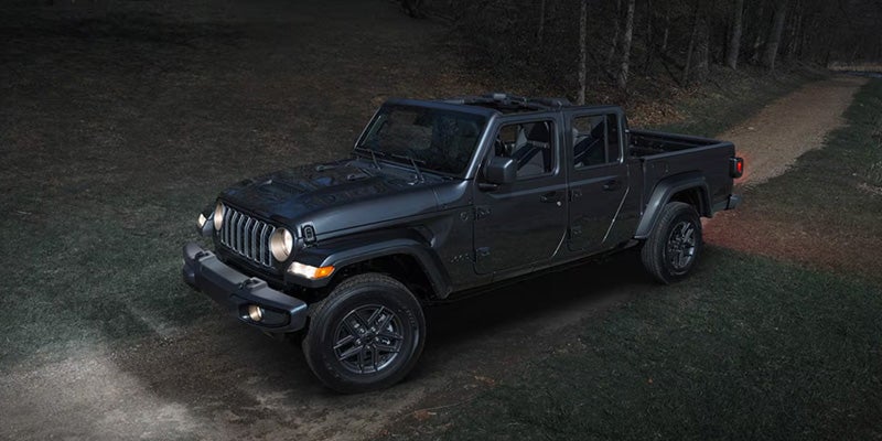 Black 2026 Jeep Gladiator parked in the middle of the forest